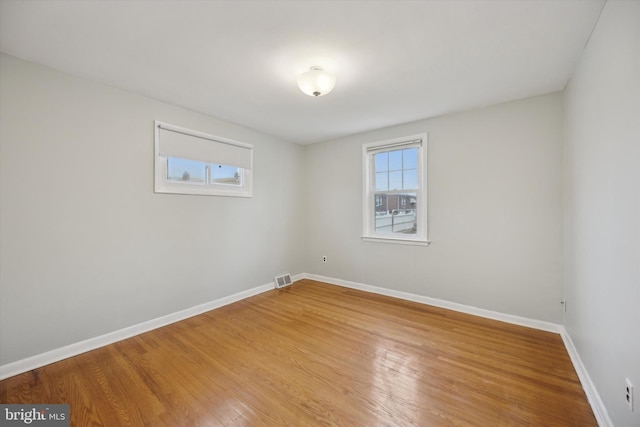 spare room with wood-type flooring