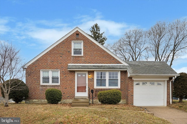 view of front of property with a garage and a front lawn