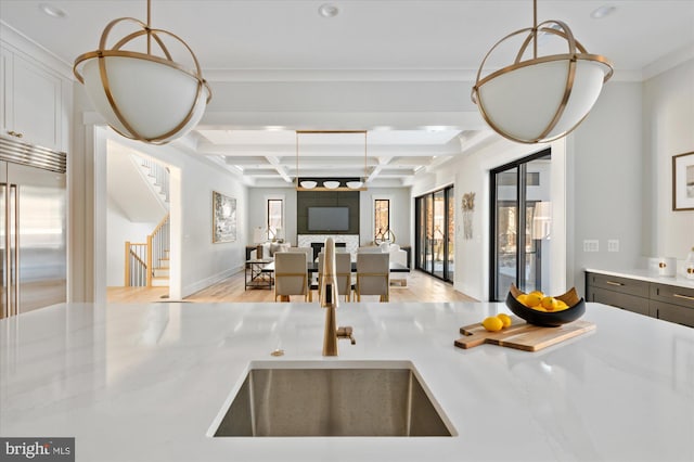 kitchen with plenty of natural light, coffered ceiling, beamed ceiling, and open floor plan