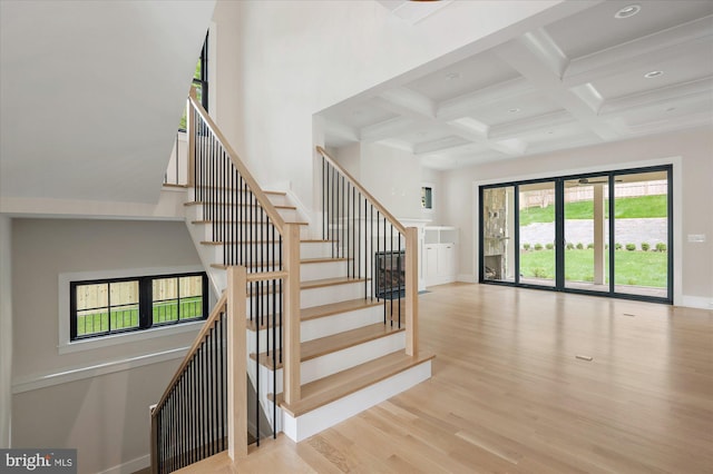 stairs with recessed lighting, coffered ceiling, wood finished floors, baseboards, and beam ceiling