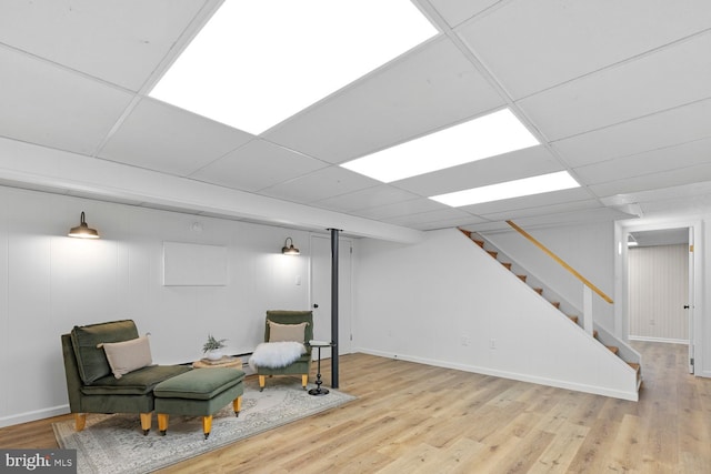 sitting room with a paneled ceiling and light hardwood / wood-style floors