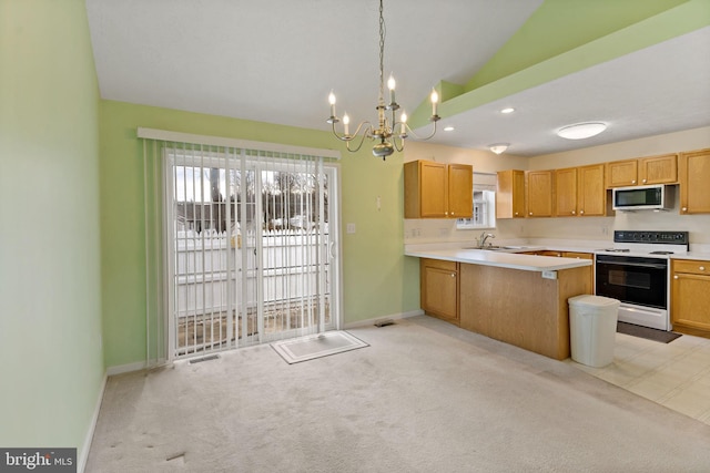 kitchen featuring sink, plenty of natural light, kitchen peninsula, pendant lighting, and white range with electric stovetop