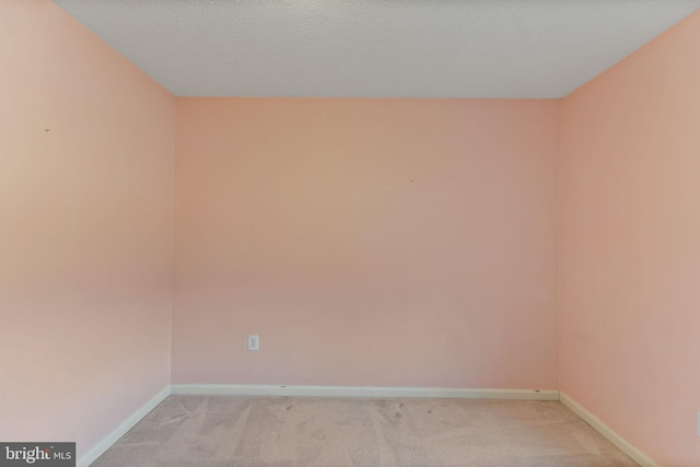 unfurnished room featuring light colored carpet