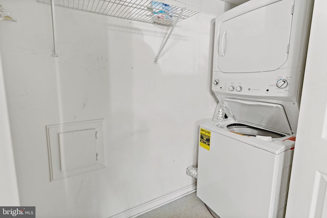 washroom featuring stacked washer and clothes dryer