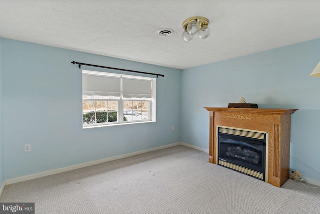 unfurnished living room featuring carpet floors and a textured ceiling