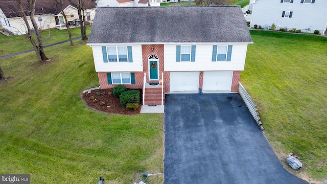 view of front of house with a garage and a front lawn