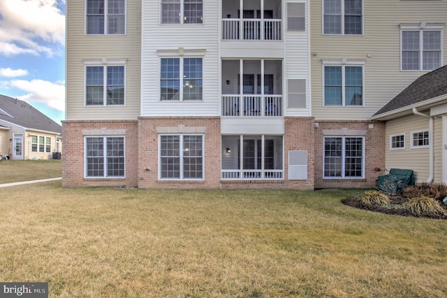 rear view of property with a lawn