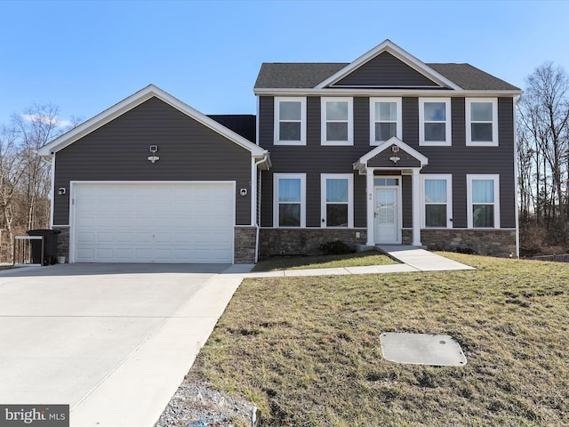 view of front of house featuring a garage and a front lawn