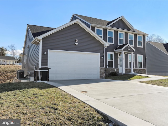 view of front of house with a garage, central AC unit, and a front yard