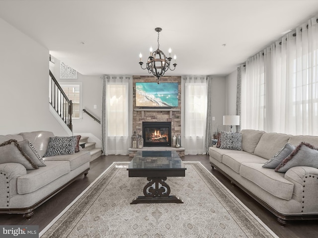 living room featuring an inviting chandelier and a fireplace