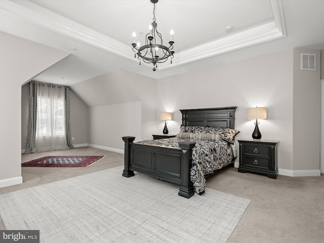 carpeted bedroom with a notable chandelier and a tray ceiling