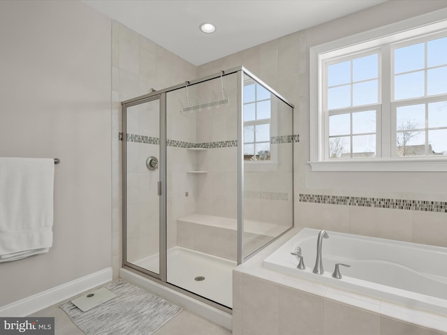 bathroom featuring shower with separate bathtub