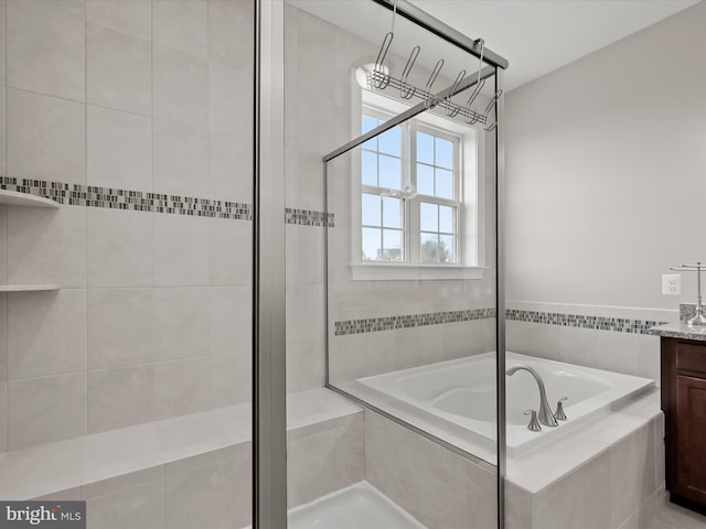 bathroom with vanity and tiled bath