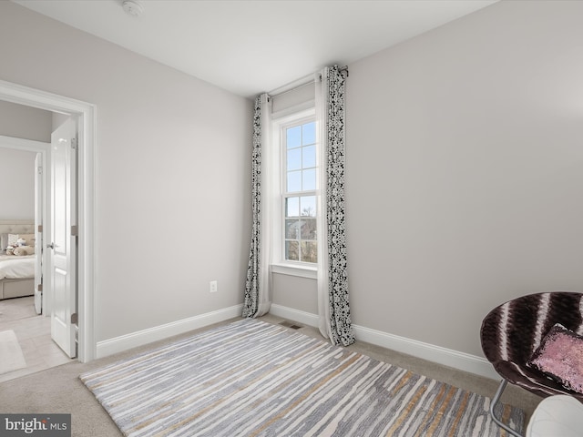 sitting room featuring light colored carpet