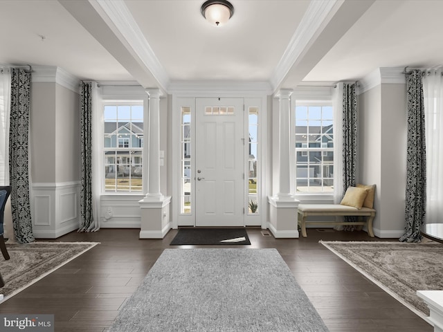 entryway with crown molding and decorative columns