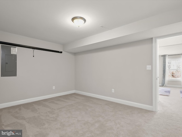 basement with light colored carpet and electric panel