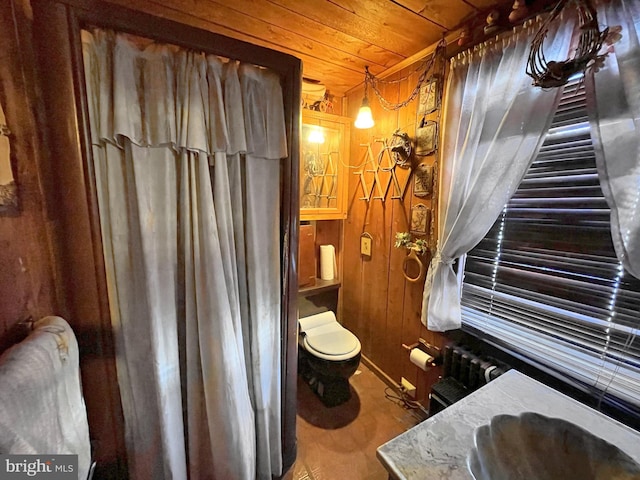 bathroom featuring radiator, wood ceiling, sink, wood-type flooring, and wood walls