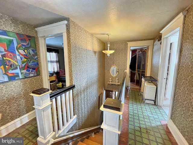 hallway with a textured ceiling