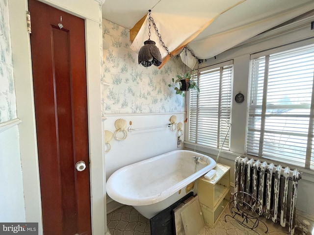 bathroom with radiator and a bathtub