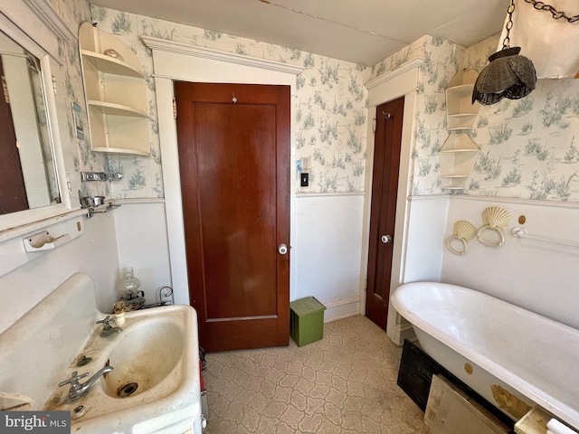 bathroom with a washtub and vanity