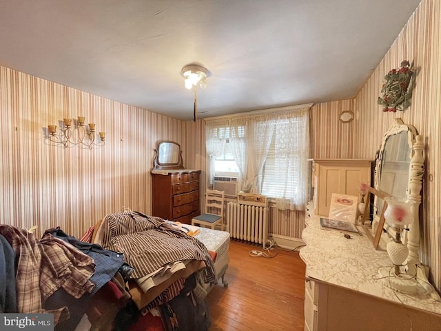 bedroom with radiator and light wood-type flooring