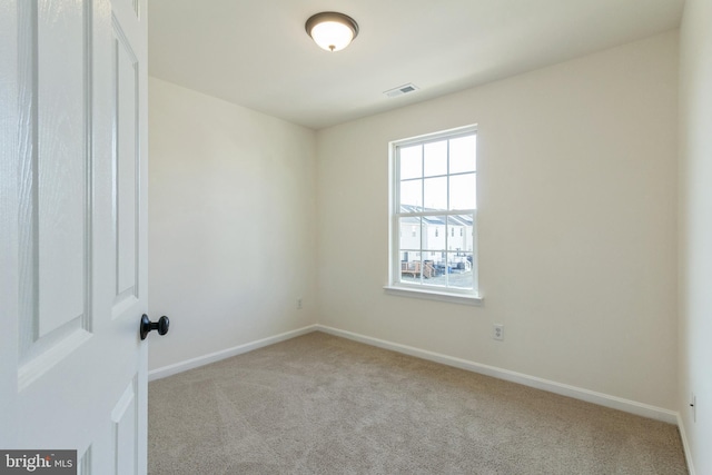 empty room featuring light carpet