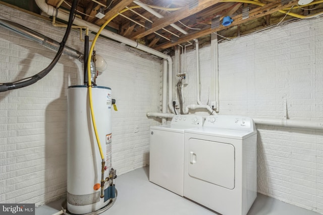 laundry room with independent washer and dryer, brick wall, and water heater