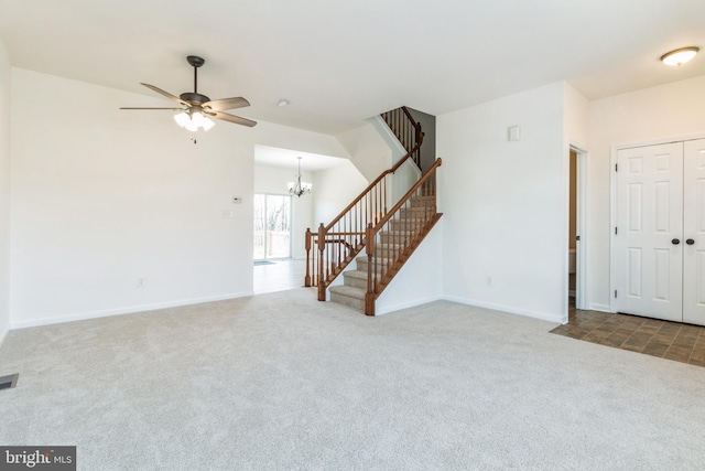 unfurnished living room with carpet and ceiling fan with notable chandelier