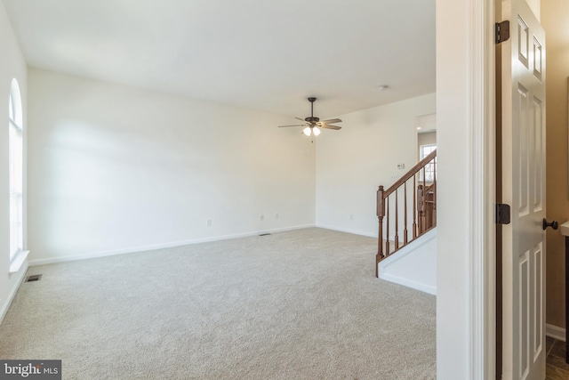 empty room with ceiling fan and carpet flooring