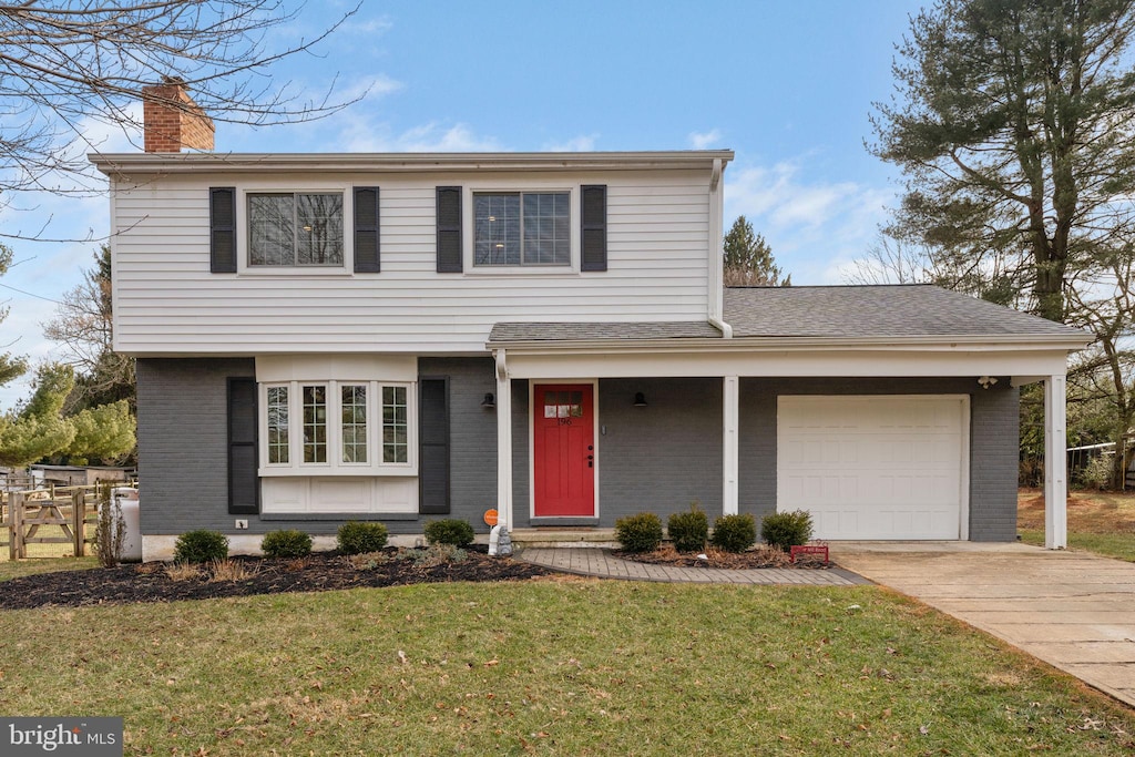 front facade featuring a garage and a front lawn