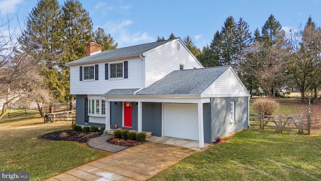 view of front property with a garage and a front yard