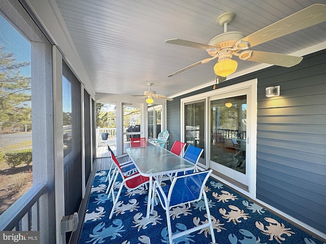 sunroom / solarium with ceiling fan