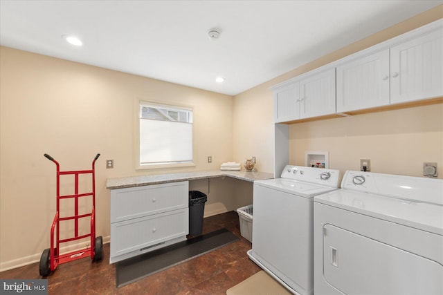 clothes washing area featuring cabinet space, baseboards, and separate washer and dryer