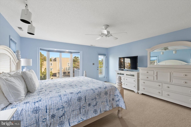 bedroom with visible vents, a ceiling fan, light colored carpet, access to outside, and a textured ceiling