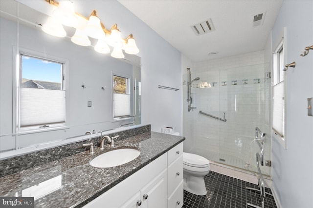 bathroom with toilet, vanity, visible vents, a shower stall, and tile patterned floors