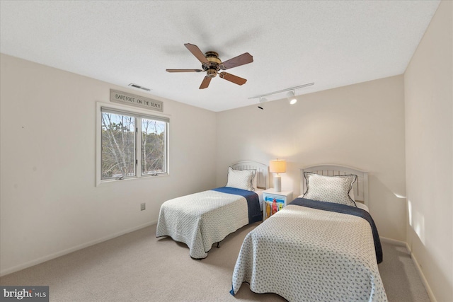 bedroom with carpet, visible vents, and baseboards