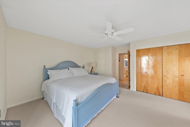 bedroom featuring a ceiling fan, a closet, and carpet flooring