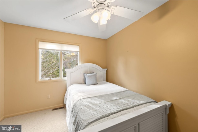 carpeted bedroom with a ceiling fan, visible vents, and baseboards