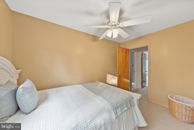 carpeted bedroom featuring ceiling fan and baseboards