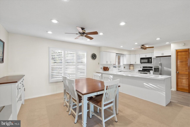 dining area with light carpet, baseboards, a ceiling fan, and recessed lighting