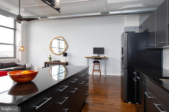 kitchen with dark hardwood / wood-style floors and stainless steel refrigerator