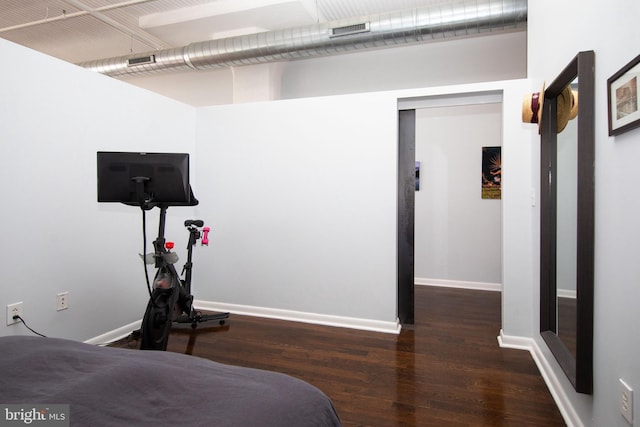 bedroom featuring dark hardwood / wood-style flooring