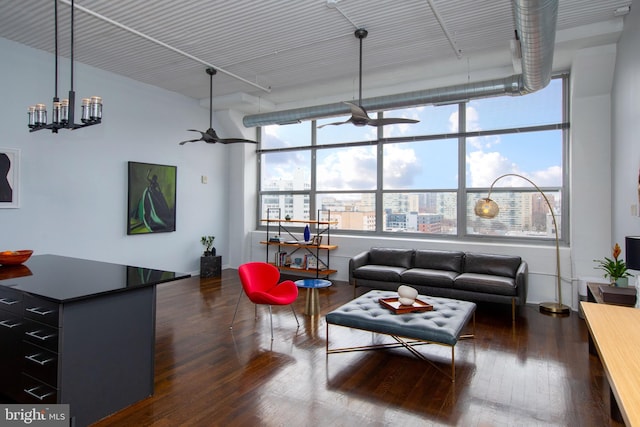 living room with dark hardwood / wood-style flooring and ceiling fan