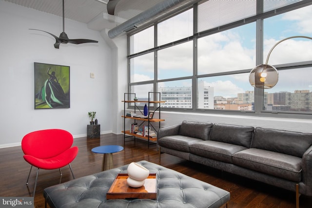 living room featuring ceiling fan and dark hardwood / wood-style flooring