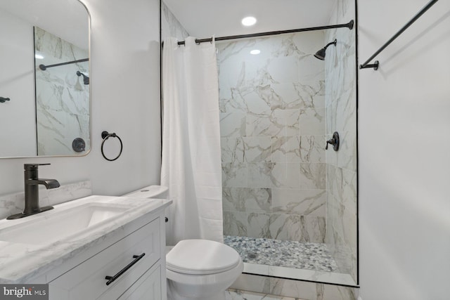 bathroom featuring toilet, vanity, and walk in shower