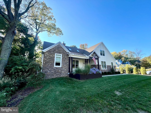 rear view of house featuring a yard