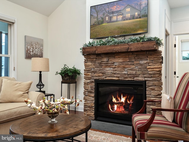 sitting room featuring a fireplace and a healthy amount of sunlight