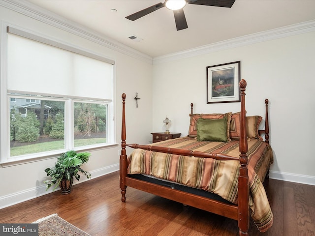 bedroom with dark hardwood / wood-style flooring, crown molding, and ceiling fan