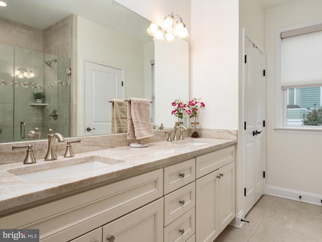 bathroom featuring an inviting chandelier, vanity, and a shower with shower door