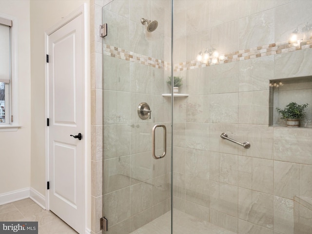 bathroom featuring a shower with shower door